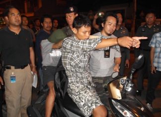 Yossakorn shows police how he drove the motorbike while the 16-year-old stabbed Nikilina in the arm and took her bag.