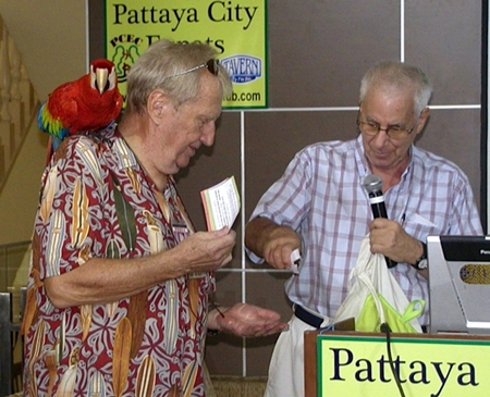 Following John’s talk, MC Richard Silverberg helps ‘Hawaii Bob’ Sutterfield with the Frugal Freddy lucky draw.