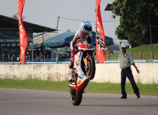 Ben Fortt pulls a wheelie in celebration as he crosses the finish line to win round 9 of the SB-2 Superbike championship.