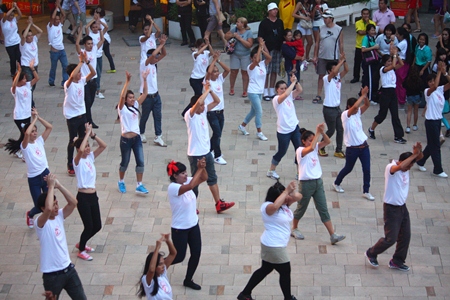 Hilton employees perform a mass dance demonstration outside Central Festival Pattaya Beach.