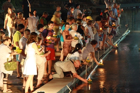 Tourists at Nong Nooch Tropical Gardens float their krathongs.