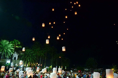 Dozens of khomloys are released into the night sky.