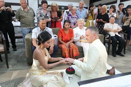 Ingo and Natthakarn exchange wedding rings symbolizing unconditional love and mutual respect for each other.