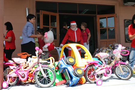 Santa arrives bearing gifts for the children.