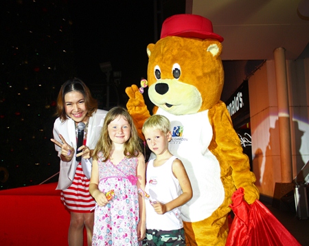 Mr. Happiness Bear hands out treats to young children during the official Christmas and New Year’s launch at the Royal Garden Plaza. 