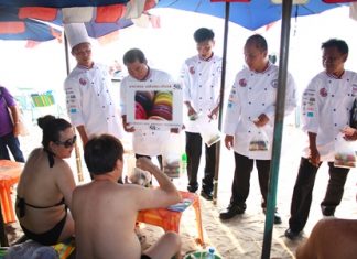 Chefs solicit donations through selling macaroons to tourists on Pattaya Beach.