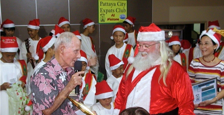 Board member Richard Smith thanks Santa for taking the time to visit & to give out presents to the children. Toy looks on.