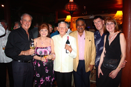 Peter Malhotra presents a bottle of wine to Archie. From left: Dr. Iain Corness, Elfi Seitz, Archie Dunlop, Peter Malhotra along with Arthur & Alisa. 