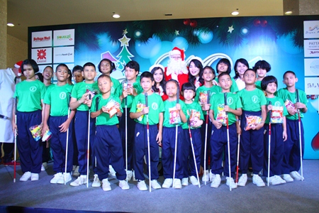 Children from Redemptorist School for the Blind receive sweets from Santa and his helpers.