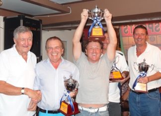 Paul Smith (center) celebrates as captain of the winning team in the John Preddy tournament and Golfer of the Month for November.