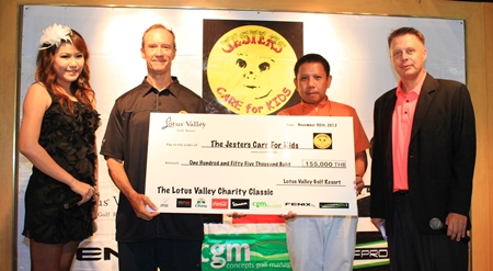 Lewis Underwood (2nd left) accepts a cheque on behalf of the Jesters Care for Kids for money raised by the Lotus Valley Charity Classic.