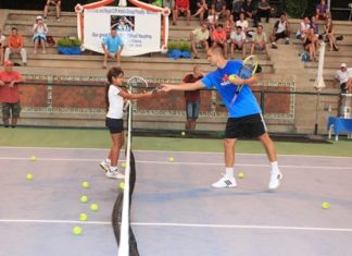Mikhail Youzhny interacts with a young Fitz Club member giving her valuable tennis tips.