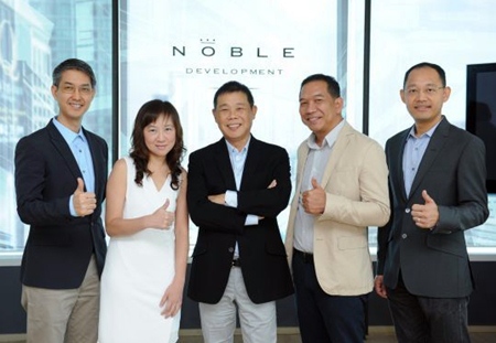 Kitti Thanakitamnuay, Chairman and CEO of Noble Development PLC (center) poses with other Noble directors at the announcement of the company’s plans for 2013. 
