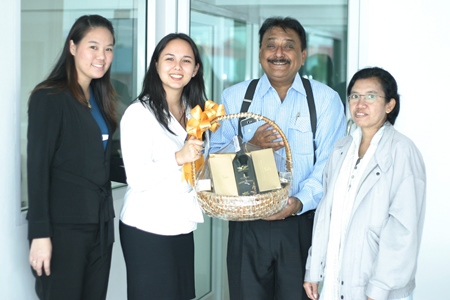 Peter Malhotra, MD of Pattaya Mail Media Group, is elated as he receives a basket of good cheer from Victoria Arnold, PR & Marketing Communications Manager, and Somruthai Chomrat (left), Assistant Marketing Communications Manager from the Royal Cliff Hotels Group with greetings from the top management of the Royal Cliff. At right is Primprao Somsri, Advertising Sales & Marketing Manager of the Pattaya Mail Media Group.