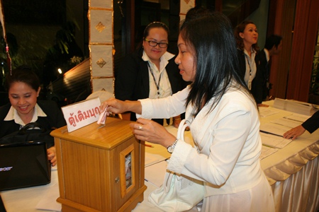 Guests make merit during the evening session.