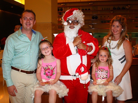 Holiday Inn General Manager Garth Solly (left) and his family pose with Santa for Christmas.