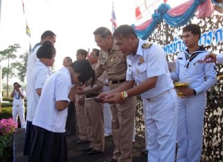 Capt. Sompong Phuwieng leads a presentation of 88,500 baht in scholarships.