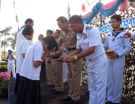 Capt. Sompong Phuwieng leads a presentation of 88,500 baht in scholarships.