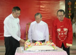 The three clergymen men admire the beautiful birthday cake (from left) Bishop Silvio, Bishop Lawrence and Father Michael.