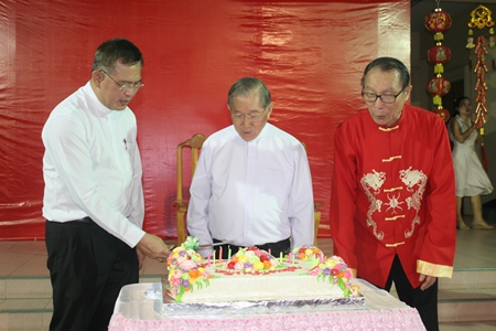 The three clergymen men admire the beautiful birthday cake (from left) Bishop Silvio, Bishop Lawrence and Father Michael. 