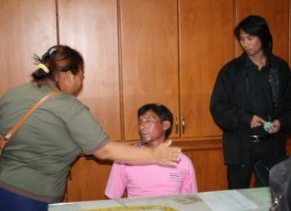 Peng Chanatlay (seated) receives a slap on the face from his now ex-girlfriend, mother of the child he stands accused of raping.