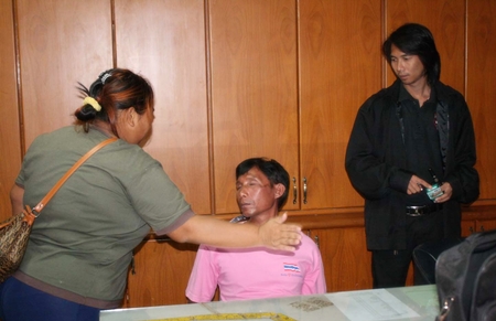 Peng Chanatlay (seated) receives a slap on the face from his now ex-girlfriend, mother of the child he stands accused of raping.