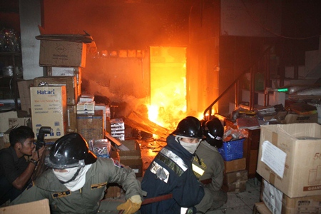 Firefighters move in to contain the blaze at Silpaban office supplies store. 