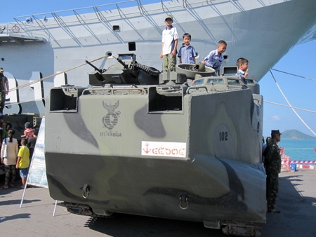 Young Marines PFC Bret Mays (left) stands with other kids on a Royal Thai Marine Corps AAVP-7. The bow of the Royal Thai Navy’s Aircraft Carrier, CVS 911, can be seen in the background.