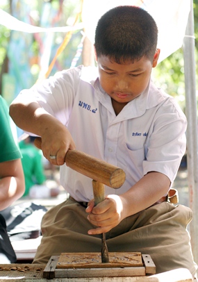 A future sculptor concentrates on his wood carving at the Sanctuary of Truth.