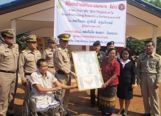 Petty Officer 1st Class Suthin Seemuang and family receive their house from the Royal Thai Navy.