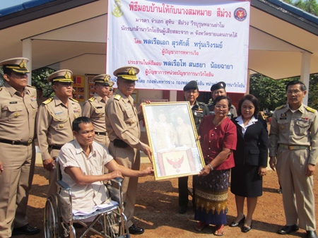 Petty Officer 1st Class Suthin Seemuang and family receive their house from the Royal Thai Navy.