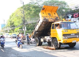 Pattaya’s “pothole patrol” fills holes and levels surfaces along Second Road.