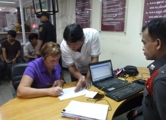 Russian victim Nina Vitiutneva fills out a police report after being robbed on the ocean side of Pratamnak Hill.