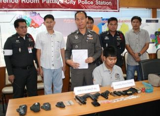 Chonburi Police Station Commander Maj. Gen. Khatcha Thatsart (standing center) announces results of the recent crackdown on crime.