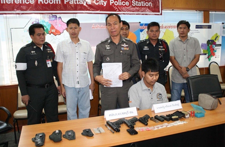 Chonburi Police Station Commander Maj. Gen. Khatcha Thatsart (standing center) announces results of the recent crackdown on crime.