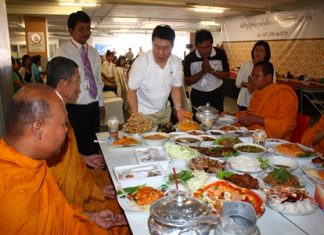 General Manager Saran Tantijamnaj (center) serves lunch to the monks during Central’s anniversary merit making.