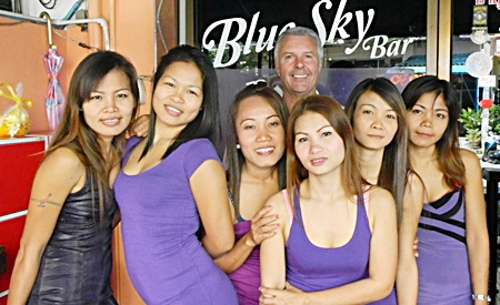 Mike ‘Michelle’ Chatt (center rear) poses with the staff at Blue Sky Bar.