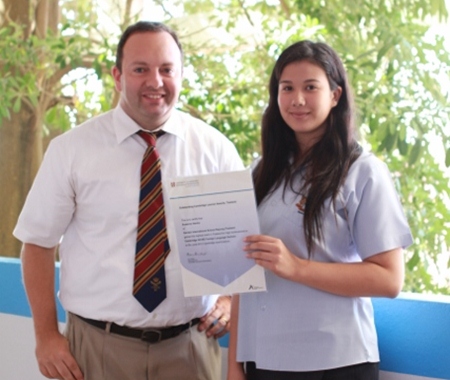 Mr Chris Stokes, IGCSE Coordinator at GIS, congratulates Susanna.