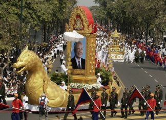 The chariot carrying the portrait of late former King Norodom Sihanouk leads his royal funeral procession Friday, Feb. 1, 2013, in Phnom Penh, Cambodia. Thousands of mourners accompanied a gilded chariot carrying the body of former King Sihanouk - the dominant figure of modern Cambodia - in a funeral procession Friday to a cremation ground next to the palace where he was crowned more than 70 years ago. (AP Photo/Heng Sinith)