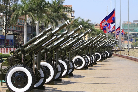 Cambodian flags fly at half-mast as cannons are placed for gun salutes during the cremation of former King Norodom Sihanouk near the Royal Palace in Phnom Penh, Monday, Feb. 4. (AP Photo/Heng Sinith)