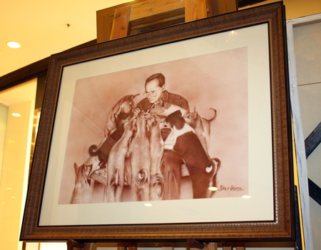 HM the King's kindness while feeding his pet dogs.