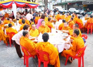 Monks from Chaiyamongkol Phra Aaramluang Temple are seated for lunch at South Pattaya’s old pier, for a merit making ceremony organized by the Sawang Boriboon Thammasathan Foundation.