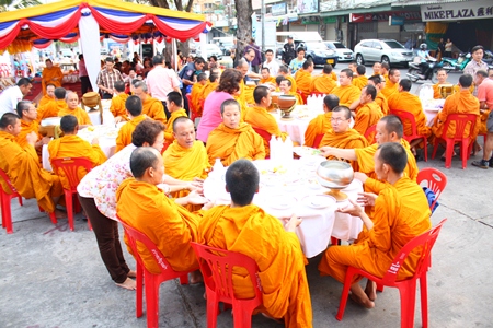 Monks from Chaiyamongkol Phra Aaramluang Temple are seated for lunch at South Pattaya’s old pier, for a merit making ceremony organized by the Sawang Boriboon Thammasathan Foundation.