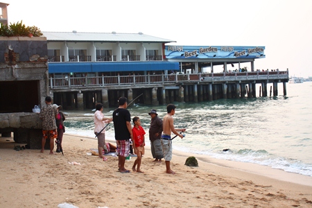 The entire family turns out for a day of fishing at the site where the old Pattaya pier once stood.