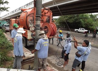 City workers perform the never-ending job of cleaning out Pattaya’s storm drains.