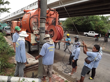 City workers perform the never-ending job of cleaning out Pattaya’s storm drains.