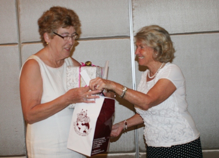 Outgoing president, Ann Winfield, accepts a thank-you gift from Kirsten Lillelund.