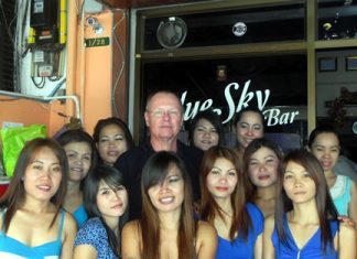 Dan ‘The Diet Whiskey Man’ (rear-center) celebrates his win with the staff at Blue Sky Bar.