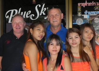The Quiet Man and Irish John pose with the staff at Blue Sky Bar.