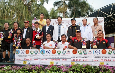 Class winners and runners-up pose with their trophies alongside city dignitaries and tournament officials.